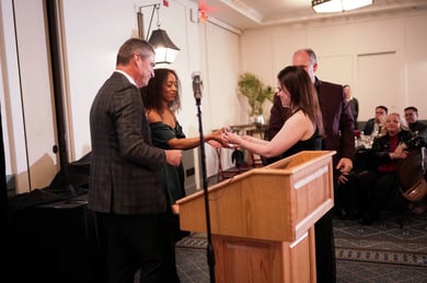 Ashley Buckmaster receiving award from Alyssa Garcia with Titus Crabb and Bob Morris at the 2023 Vertech Christmas Party 